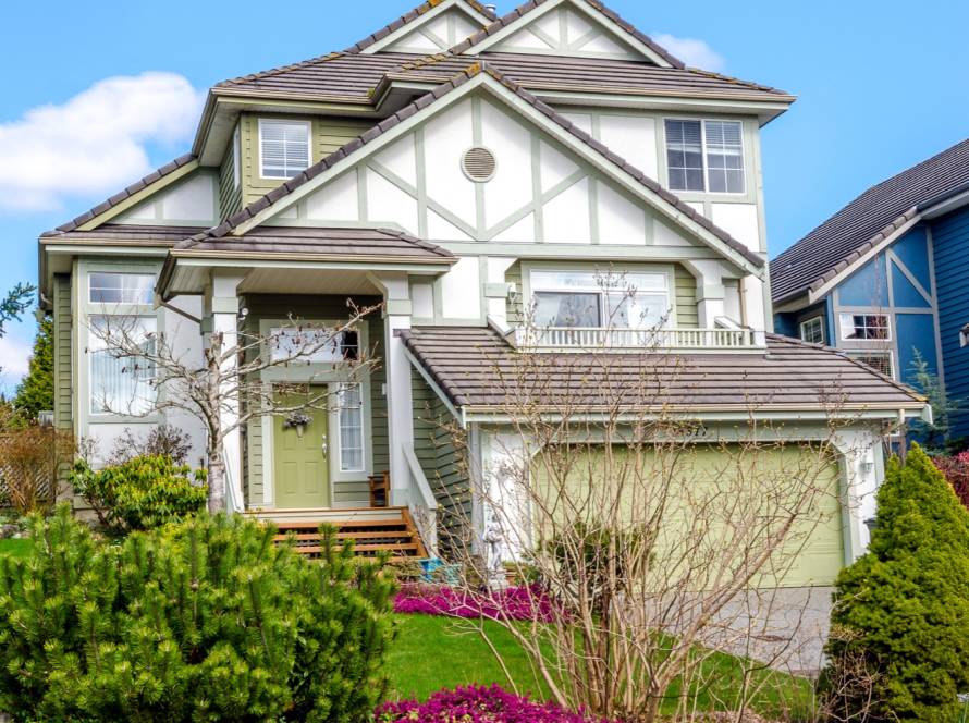 Suburban house exterior painted green and white