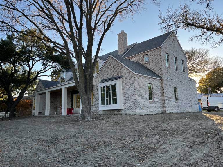 Finished home exterior with painted brick and trim