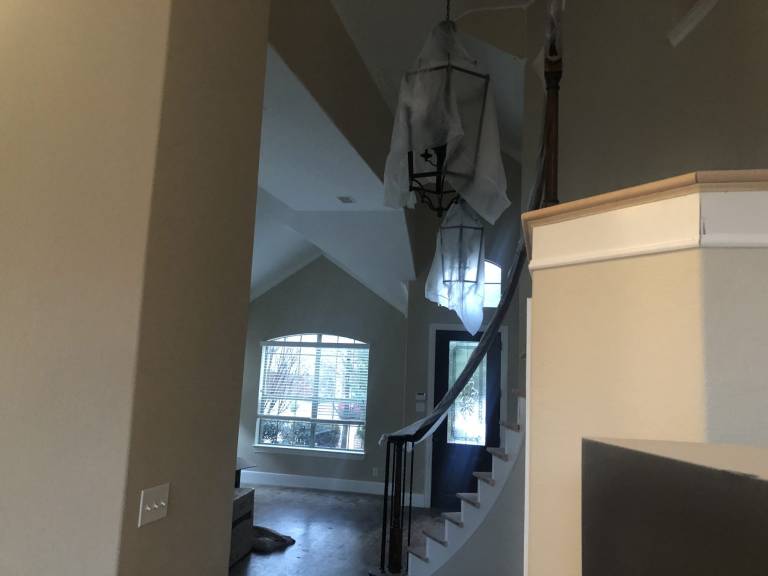 Two-story entry and staircase freshly painted in a warm neutral