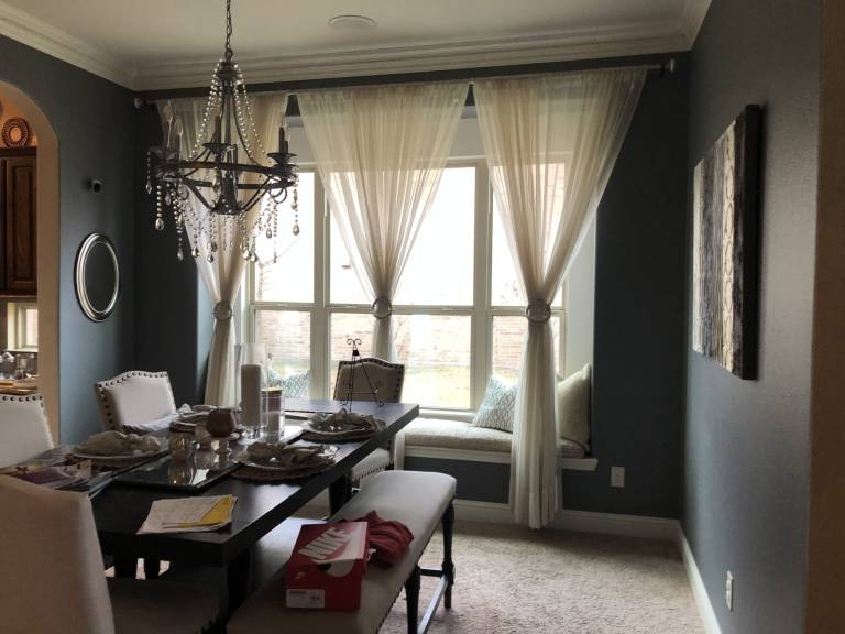 Dining room with gray walls and white trim after painting