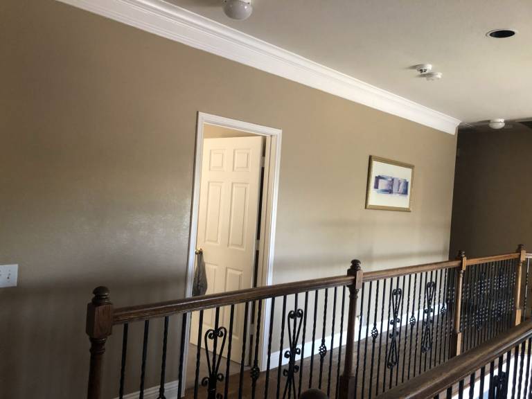 Upstairs hallway and railing after repainting
