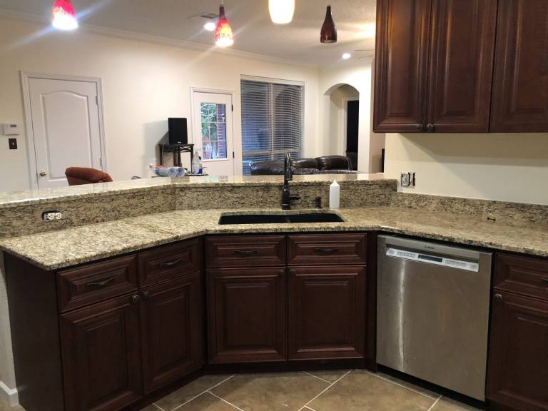 Kitchen with granite counters and refreshed cabinets